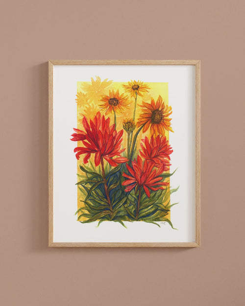 Framed artwork of red and yellow flowers on a wall painted Iced Copper by Behr.