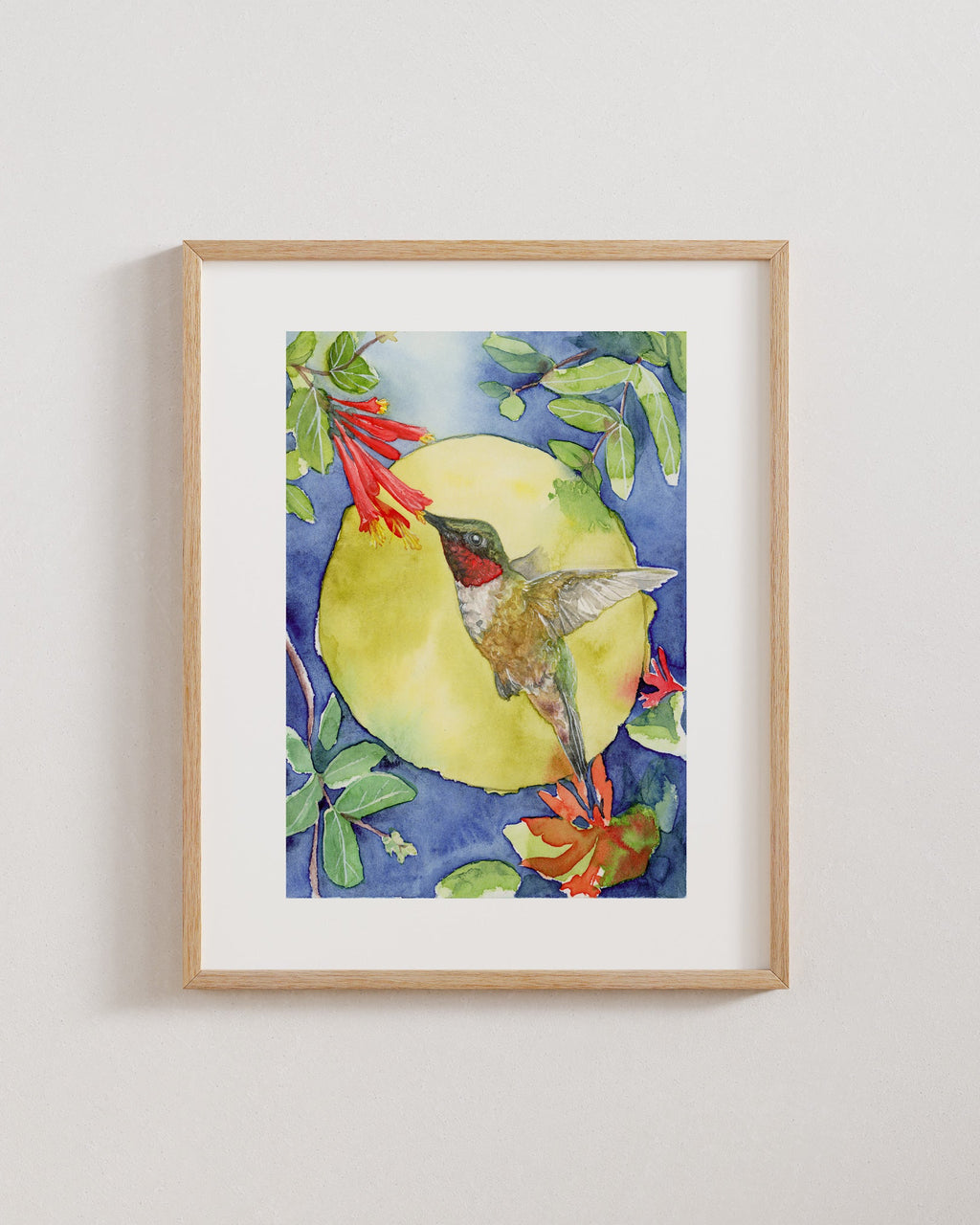 Framed artwork of a hummingbird on a floral background