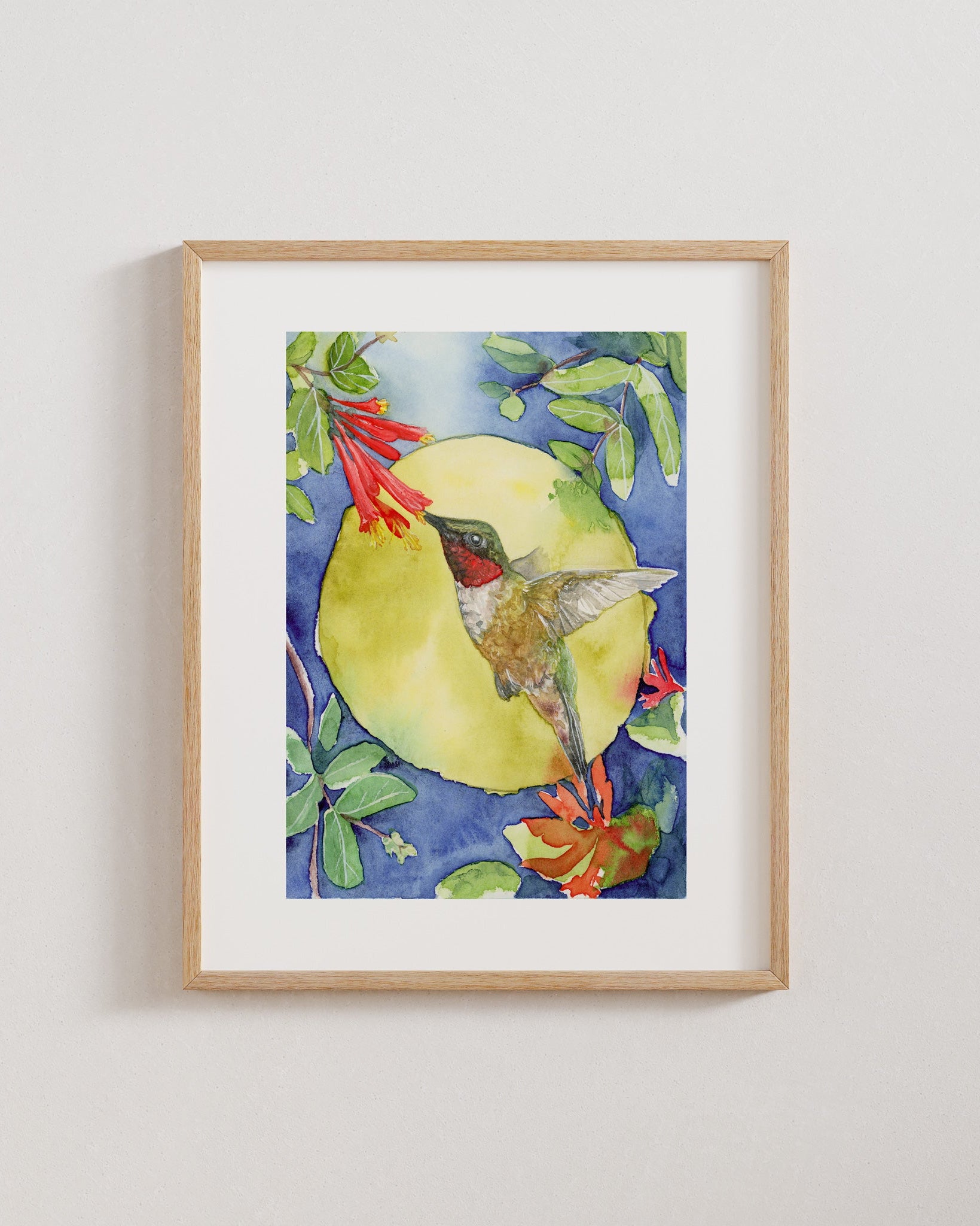 Framed artwork of a hummingbird on a floral background
