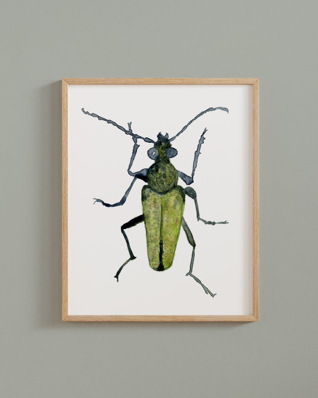 Framed artwork of a yellow velvet beetle on a white background